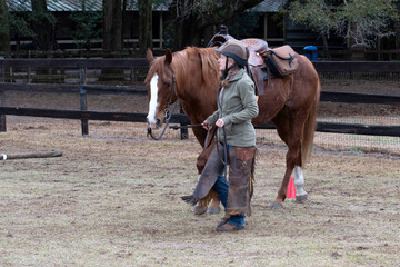 A woman doing an obstacles course with her horse