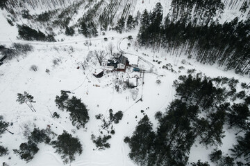 A view of a snow-covered house, seen from a drone
