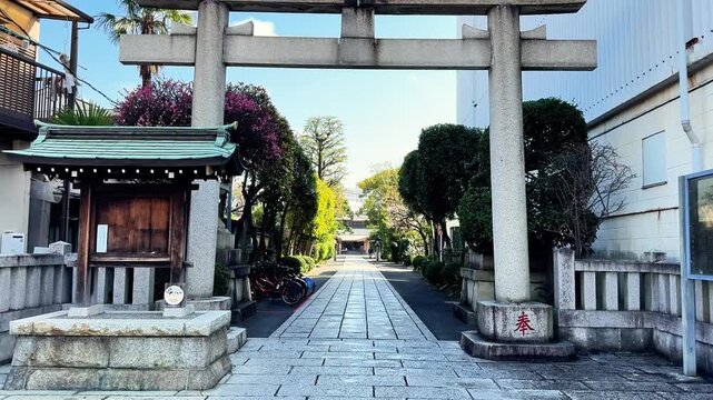 Stone torii entrance on a quiet Japanese neighborhood street