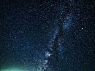 High resolution astrophotography of summer Milky Way, Summer Triangle and green airglow. Dense starfield with Cygnus constellation and countless pinpoint stars filling the dark deep space. © Ryuichiro Abe