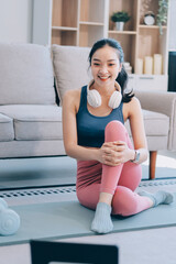 Young Asian sporty attractive people practicing yoga lesson with instructor. Asia group of women exercising healthy lifestyle in fitness studio. Sport activity, gymnastics or ballet dancing class.