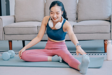 Young Asian sporty attractive people practicing yoga lesson with instructor. Asia group of women exercising healthy lifestyle in fitness studio. Sport activity, gymnastics or ballet dancing class.