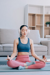 Young Asian sporty attractive people practicing yoga lesson with instructor. Asia group of women exercising healthy lifestyle in fitness studio. Sport activity, gymnastics or ballet dancing class.