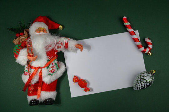 Ded Moroz Figurine Surrounded by Christmas Decorations on Paper