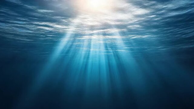 Underwater scene depicts sunlight filtering through the surface of water, creating rays