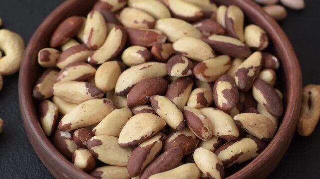 Brazil nuts, raw and shelled, are a source of selenium and a healthy food ingredient. Brazil nuts as a food background for your design