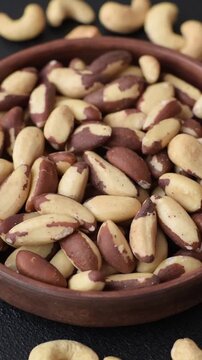 Brazil nuts, raw and shelled, are a source of selenium and a healthy food ingredient. Brazil nuts as a food background for your design
