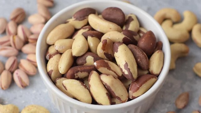 Brazil nuts, raw and shelled, are a source of selenium and a healthy food ingredient. Brazil nuts as a food background for your design