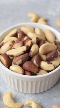 Brazil nuts, raw and shelled, are a source of selenium and a healthy food ingredient. Brazil nuts as a food background for your design