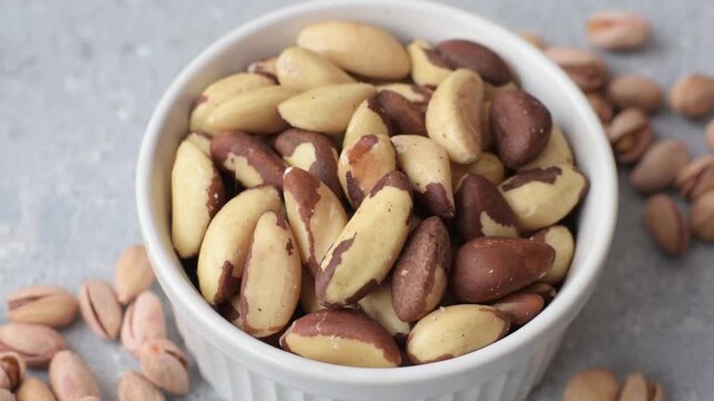 Brazil nuts, raw and shelled, are a source of selenium and a healthy food ingredient. Brazil nuts as a food background for your design