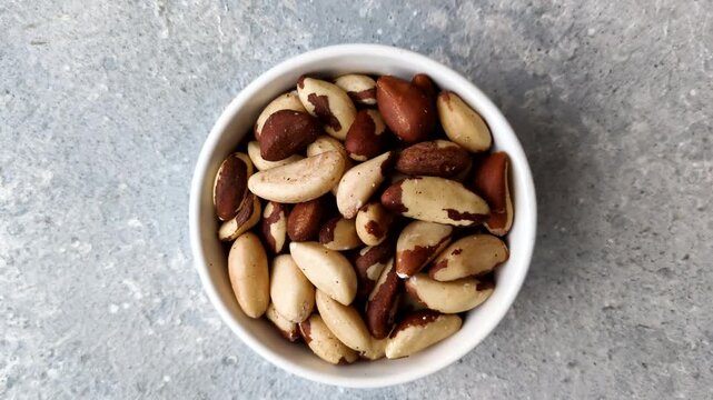 Brazil nuts, raw and shelled, are a source of selenium and a healthy food ingredient. Brazil nuts as a food background for your design
