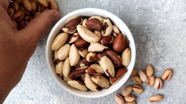 Brazil nuts, raw and shelled, are a source of selenium and a healthy food ingredient. Brazil nuts as a food background for your design