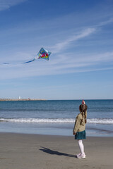 Girl flying kite on beach