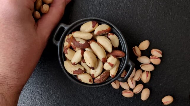 Brazil nuts, raw and shelled, are a source of selenium and a healthy food ingredient. Brazil nuts as a food background for your design
