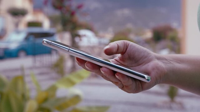 Female in Casual Clothes with Mobile Phone in Hand Outdoors in Village Looking for Information Online