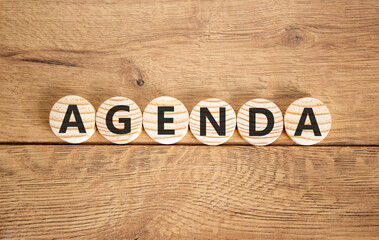 Agenda symbol. Concept word Agenda on beautiful wooden circles. Beautiful wooden background. Business agenda concept. Copy space.