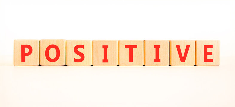 Positive word symbol. Concept word Positive on beautiful wooden blocks. Beautiful white background. Business support help positive word concept. Copy space.