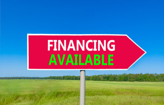 Financing available symbol. Concept words Financing available on beautiful red road sign. Beautiful blue sky green grass field background. Business financing available concept. Copy space.