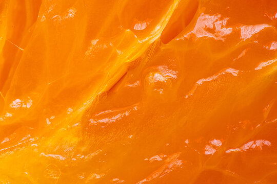 Extreme Macro Texture of Fresh Juicy Orange Pulp,A vibrant, high-detail macro shot showcasing the glistening, translucent juice vesicles of a fresh orange. The intense orange hue and organic textures 
