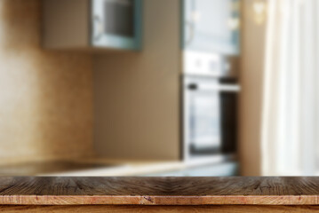 Wooden table top with blurred kitchen interior background