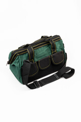 Green canvas bag with black trim and handles on a white background.