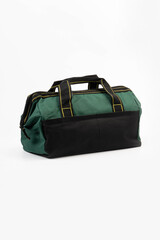 Green canvas bag with black trim and handles on a white background.