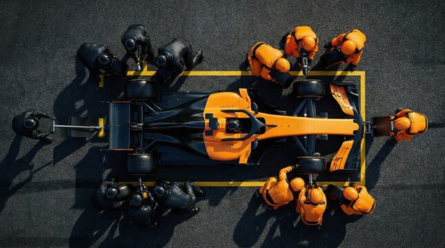 Birds eye view orange and black formula race car serviced by pit crew. Concept of competitive motorsport logistics, high speed pit lane service, professional race team performance.