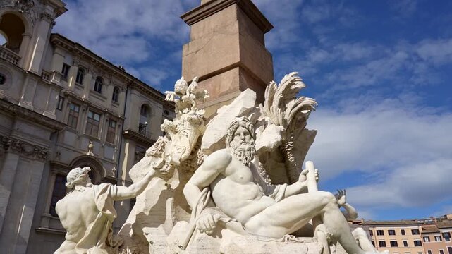 Famous monumental fountain of the Four Rivers by Gian Lorenzo Bernini in Piazza Navona, a spectacular baroque artwork with an Egyptian obelisk at its center, located in Rome, Italy