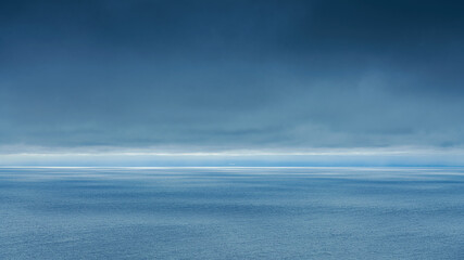 Obraz premium A panoramic aerial view of the Pacific Ocean with low-flying dense clouds obscuring the sky, Muroran, Hokkaido, Japan