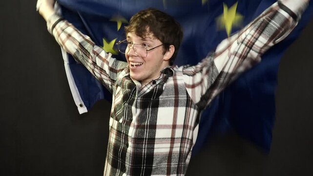 A football fan rejoices at his team's victory and shouts hurray.