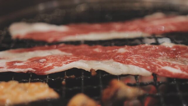 Galbi sizzling Korean BBQ experience showing dynamic cooking action with smoke and grill marks for authentic restaurant scene.