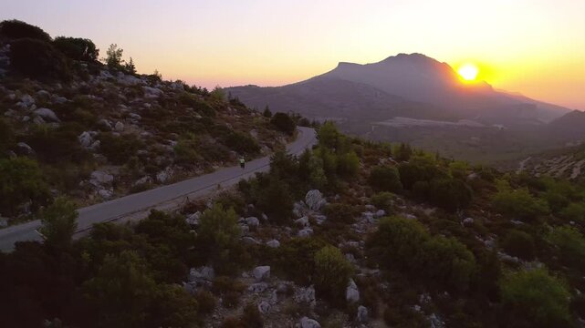Obese Woman Training Outdoors in Beautiful Mountain Landscape During Evening Jogging Session, drone view