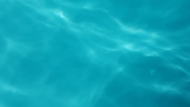 Clear blue water surface with sun reflections