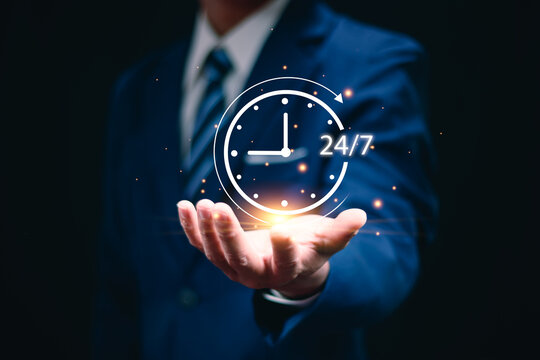 Nonstop service concept. Businessman hand holding virtual 24-7 with clock on hand for worldwide nonstop and full-time available contact of service concept. Customer service, customer care, contact us.