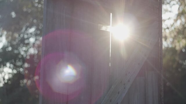 sunlight through church door cross