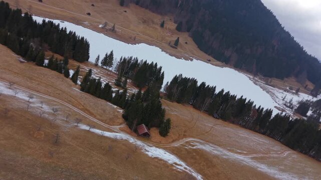 Snow-covered Wagenbruchsee Geroldsee from above. A scenic drone shot of the Kruen municipality in Upper Bavaria. A major tourist attraction in the Karwendel mountain range.
