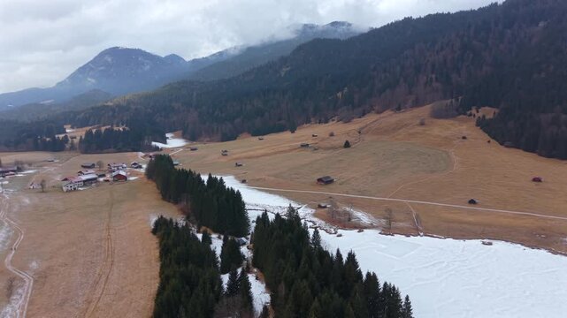 Winter landscape of Wagenbruchsee Geroldsee from above. Snowy lake in the Kruen region of Germany. A popular tourist hub in the heart of the Bavarian mountain range.