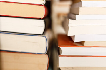 Close up photo of stacked books in library or bookstore with a neutral color tone. Education,...