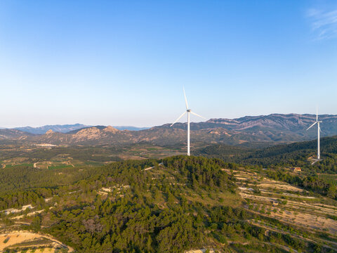 Panorama landscape with wind turbines in Terra Alta Catalonia Spain showcasing sustainable renewable energy from wind over hills in daylight