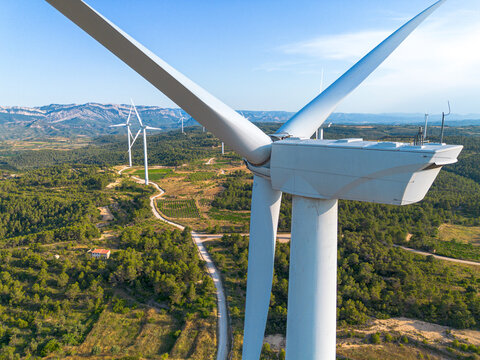 Aerial wind turbine in landscape of Terra Alta Catalonia Spain delivering sustainable renewable energy from wind under daylight sky