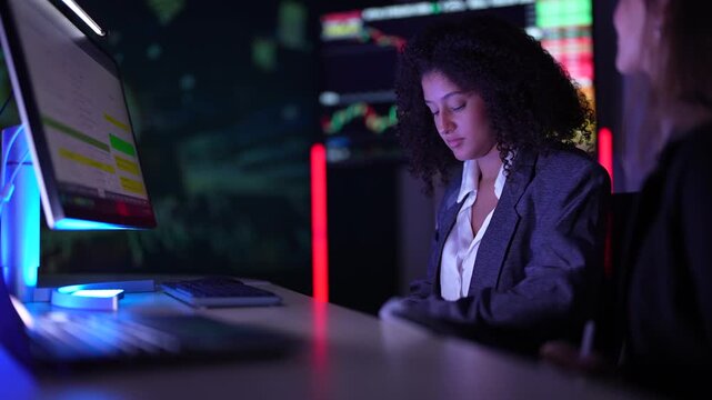 Cybersecurity analysts monitoring real-time network threat logs in dark security operations center. Digital forensic experts auditing malware code syntax during late night shift.