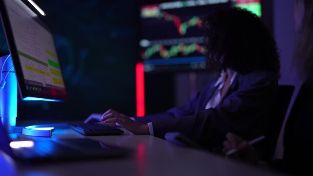 Senior software developers debugging complex backend cloud infrastructure code. Female data science engineers reviewing predictive AI algorithms on digital tablet and monitor.