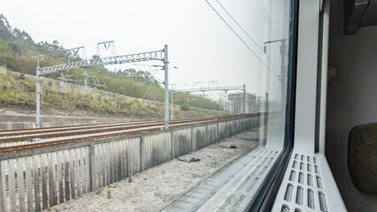 Fototapeta premium Railway Tracks View from a High-Speed Train Window
