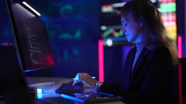 Cybersecurity analyst monitoring real-time network threat logs in dark security operations center. Digital forensic expert auditing malware code syntax via tablet interface.