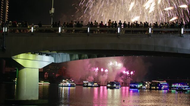 Large Fireworks Display in Sky Above City Lights