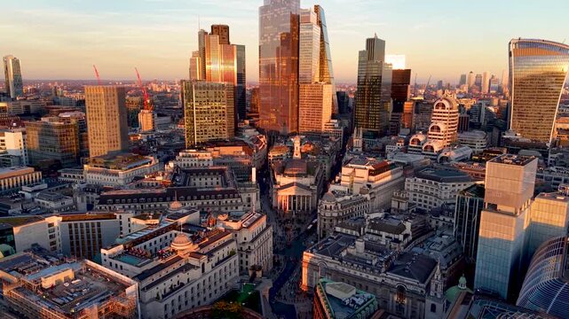Establishing aerial view of the City of London skyline with Bank and Cornhill during golden sunset time