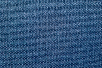Dark blue woven fabric texture background with detailed textile pattern and rich surface structure.
