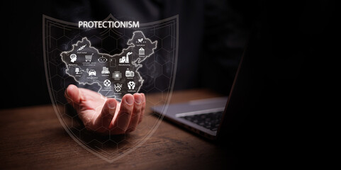 Protectionism concept. A man with laptop holding country inside digital shield with icon. Domestic industry, trade barrier, protective tariff, quota, subsidy, duty, export control, import restriction