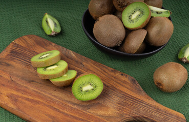 Kiwi fruits slices on wood cutting board