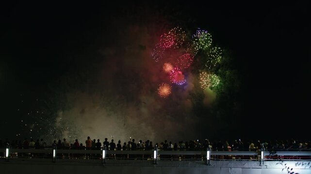 Colorful Night Fireworks Over High Rise Buildings